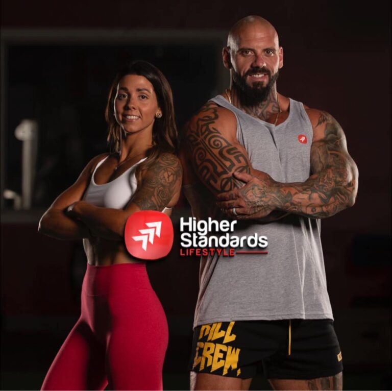 🔥 Kicking Off Something Big: Our Partnership With Higher Standards Lifestyle 1 Kyle and melissa rayner standing confidently with arms crossed, representing higher standards lifestyle fitness coaching.
